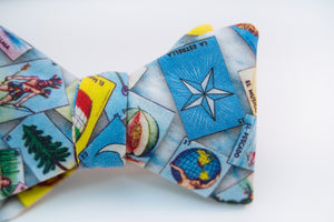 Loteria themed bow tie with dozens of possibilities of what you might get when you place your order. A lightweight cotton bow tie hoast the Loteria board game with blue/white hues as its background.   No Loteria pattern placement is guaranteed as each bow tie will vary slightly.   Height: 3" x Width: 4.25" x Knot Size: .75 (Approx.)  Dry Clean Only