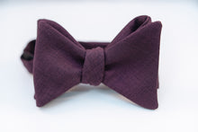 A lustrous 100% virgin wool bow tie with hues of violet and a very light hint of black wool with this two-tone butterfly bow tie. This bow tie is reserved for those who want to distinguish themselves apart from the average wool bow ties and elevate their wardrobe.  100% Virgin Wool. Imported from Italy.  Height: 3" x Width: 4.25" x Knot Size: .75 (Approx.)  Dry Clean Only