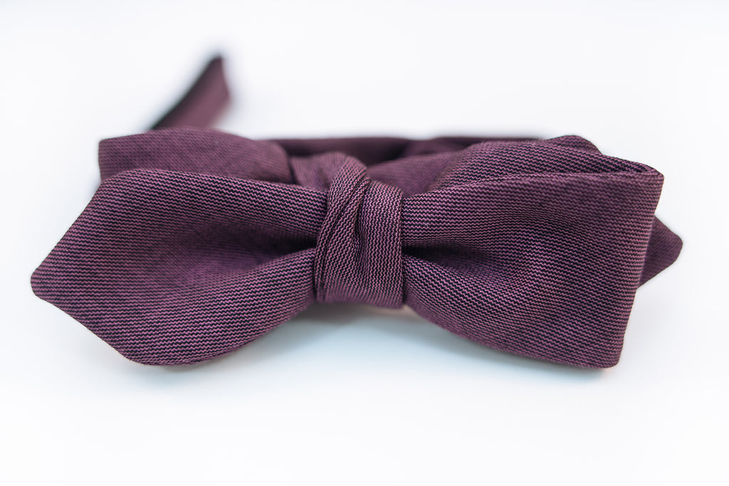 A lustrous 100% virgin wool bow tie with hues of violet and a very light hint of black wool with this two-tone butterfly bow tie. This bow tie is reserved for those who want to distinguish themselves apart from the average wool bow ties and elevate their wardrobe.  100% Virgin Wool. Imported from Italy.  Height: 1.75