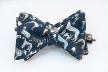 Calling all dog lovers, this lightweight cotton poplin bow tie with dog print on a navy background is the ultimate way to show your love for your favorite pup.   Height: 3" x Width: 4.25" x Knot Size: .75 (Approx.)  Dry Clean Only
