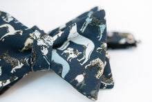 Calling all dog lovers, this lightweight cotton poplin bow tie with dog print on a navy background is the ultimate way to show your love for your favorite pup.   Height: 3" x Width: 4.25" x Knot Size: .75 (Approx.)  Dry Clean Only