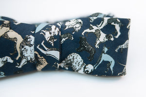 Calling all dog lovers, this lightweight cotton poplin bow tie with dog print on a navy background is the ultimate way to show your love for your favorite pup.   Height: 3” x Width: 4.5" Knot Size: .75” (Approx.)   Dry Clean Only