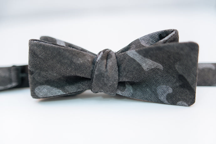 A black & grey Camouflage Cotton Bow Tie.  Height: 3” x Width: 4.5