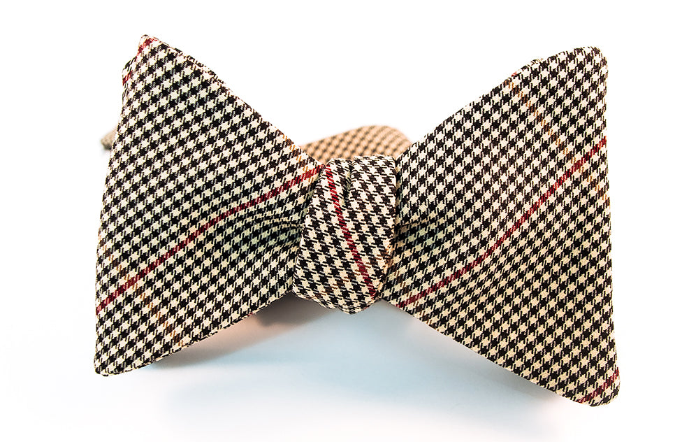 A two-toned windowpane check bow tie with colors of black, red, and beige in this lightweight twill bow tie.   Height: 3