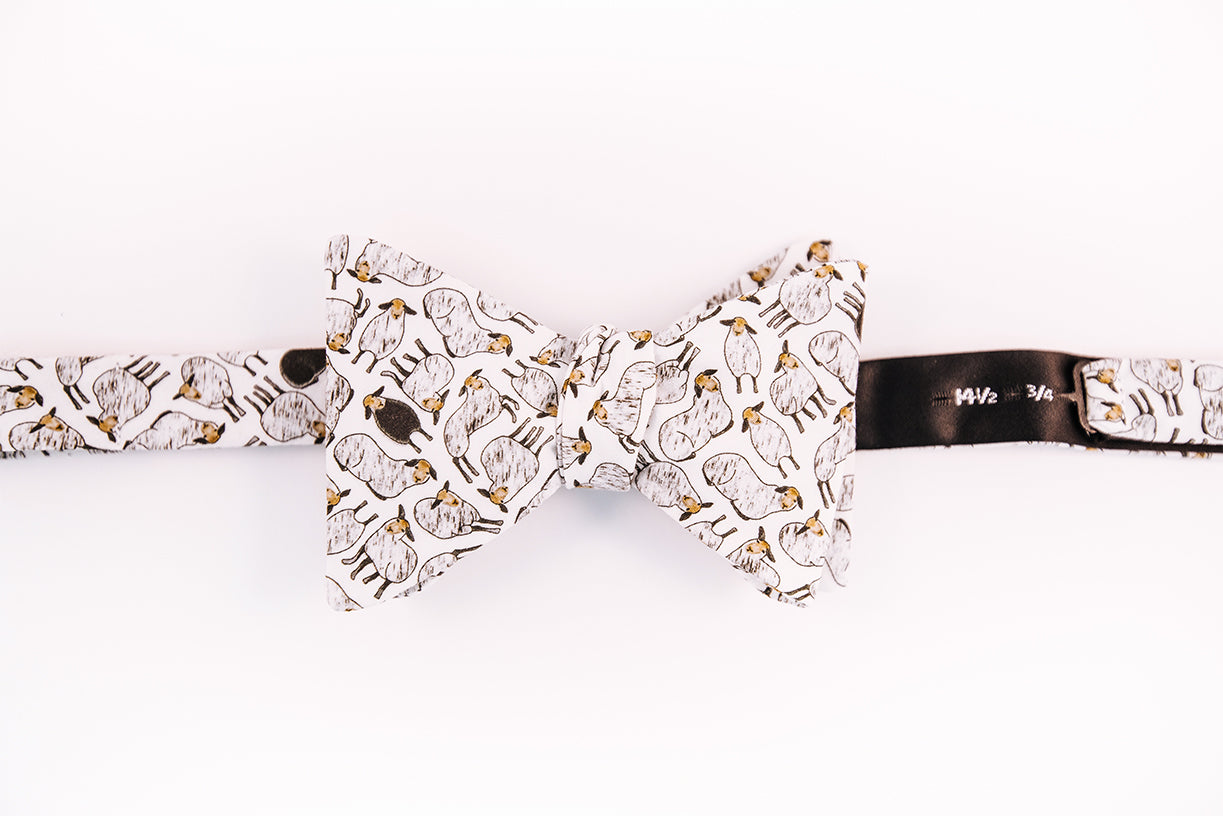 black sheep cotton bow tie with a butterfly design.