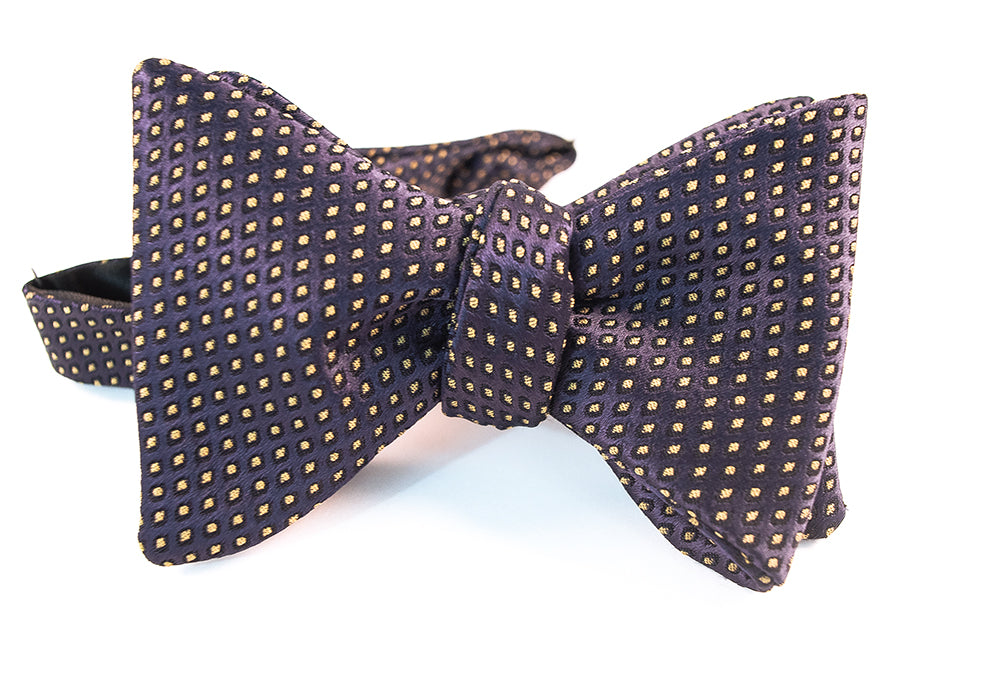 A gorgeous navy & mustard jacquard with woven polka dots dancing on elegant evening bow tie.   Height: 3” x Width: 4.5